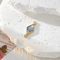 Macro detail of geometric gold pendant with real blue dried flower in resin - Rhombus Blue Flower
