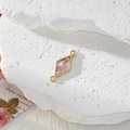 Macro detail of geometric gold pendant with real pink dried flowers in resin for DIY - Rhombus Pink Flower