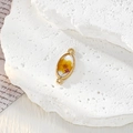 Dettaglio macro di un ciondolo dorato con veri fiori secchi in resina per gioielli fai-da-te - Fiore Giallo Ovale