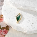 Macro view of water drop alloy connector with real green leaf preserved in clear resin - Waterdrop Green Leaf