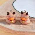 Detail of resin duck charms with reindeer antlers and golden bells for DIY jewelry - Elk Duck