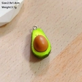 Macro detail of avocado resin pendant with size markings 2.9x1.4cm on wooden background - Avocado