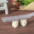 Macro shot of two cute white flocked lamb charms with metal loops for DIY jewelry making - Lamb