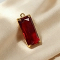 Detailed view of rectangular red crystal pendant with gold metal four-prong setting - Red