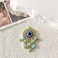 Ciondolo mano di Fatima dorato con occhio greco blu e motivi traforati raffinati - Traforato Oro Occhio Celeste