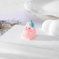 Detail of pink flocked pig pendant with blue sleeping cap on a white display stand - Sleepy Cap Pig