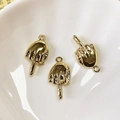 Macro shot of three gold alloy middle finger charms for punk DIY jewelry making - Middle Finger