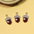 Detailed view of three enamel acorn pendants with golden alloy frames for DIY jewelry - Pine Cone