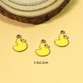 Detail view of 1.5x1.2cm yellow enamel duck pendants for DIY jewelry crafting - Duck