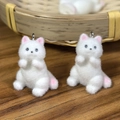 Pair of white flocked kitten pendants with pink accents and silver rings for DIY crafts - Sitting Cat