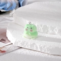 Cute light green flocked frog pendant with silver keychain ring on stone background - Frog