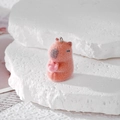 Furry orange Capybara plush pendant holding a pink heart with a metal ring attachment - Holding Lotus Style