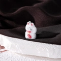 Close-up of a white flocked lucky cat pendant with red ears and a yellow bell detail - Fortune Cat