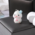 Macro view of flocking polar bear charm with pink hearts and metallic hanging loop - Blue Hat White Duck