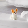 Detailed macro view of a flocked Corgi puppy pendant with a metallic silver split ring - Corgi