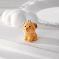 Close-up of yellow flocked puppy pendant with fluffy texture and silver metal ring - Pug