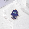 Dettaglio macro del ciondolo mano di fatima con smalto blu e occhio greco su pietra - Oro Smalto Blu 12 Pietre (U)