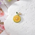 Macro view of crystal rhinestone lemon slice pendant for DIY jewelry making and earrings - Lemon