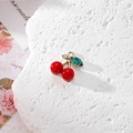 Detailed close-up of a sparkling cherry charm with red beads and golden metal leaves - Red Enamel Cherry