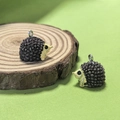 Detailed view of two resin hedgehog pendants with silver metal rings for DIY jewelry - Brown Hedgehog