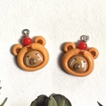 Detailed view of resin bear charms with red cherry decoration and cute weeping faces - Red Apple Style