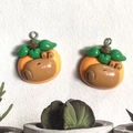 Detail of cute resin capybara charms with orange hat and leaf for DIY jewelry making - Persimmon Style