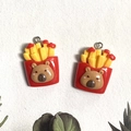 Detail of resin capybara french fries charms with red containers and yellow fries - Fries Style