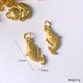 Macro detail of a matte gold fish pendant with scale texture for DIY jewelry making - Koi Fish