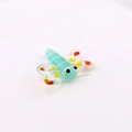 Detailed macro shot of a handcrafted light green glass dragonfly bead for DIY jewelry - Light Green Dragonfly