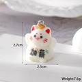 Macro shot of a white flocked lucky cat pendant with red ears and silver metal ring - Salary Increase
