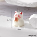 Detailed view of white flocked lucky cat charm with currency symbol and metal ring - Coin