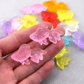 Detail of colorful resin goldfish charms with glitter for DIY earrings and necklaces - Pink Fish