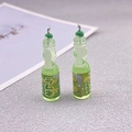 Close-up of translucent green resin melon soda bottle pendants with silver hooks - Green Bottle