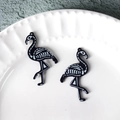 Macro view of black flamingo skeleton charms with glitter finish for DIY jewelry - Skull Flamingo