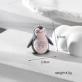 Detailed view of flocked penguin pendant with dimensions 3.1cm height and 2.9cm width - Penguin