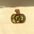 Close-up of wooden pumpkin charm with colorful star sequins for Halloween DIY crafts - Multicolor Green Star Pumpkin