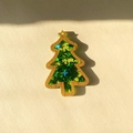 Close-up of wood Christmas tree pendant filled with green star sequins for DIY crafts - Green Star Christmas Tree
