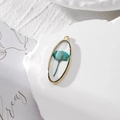Oval gold alloy pendant featuring a blue-green dried rose in clear resin casting - Cyan Rose Style (GH26)