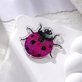 Macro detail of purple gradient acrylic ladybug pendant with glitter on stone - Purple Ladybug