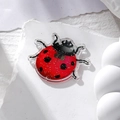 Macro shot of red glitter acrylic ladybug charm for DIY earrings and necklaces - Red Ladybug