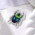 Macro view of colorful glitter ladybug pendant made of acrylic for DIY jewelry making - Green Head Blue Back Beetle