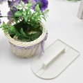 Close-up of a white plastic cake smoother with handle for smoothing cream and fondant - Plain Surface