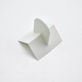 White L-shaped plastic cream scraper with a semi-circular handle for cake decorating - V-Shape