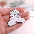 Acrylic interlocking hands pendant for Valentine jewelry making shown in palm for scale - Interlocked Fist Style (D321)