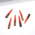Close-up of wood and resin teardrop pendants with gold foil and natural textures - Orange Water Drop