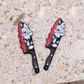 Detailed macro view of acrylic bloody knife charms with white rose floral patterns - Flower Design Fruit Knife