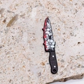Detailed view of an acrylic dagger pendant with floral patterns and red blood accents - Two Flower Carving Design (2 Flowers)