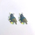 Detail view of colorful resin bird pendants with blue wings and yellow beak for DIY jewelry - Brown