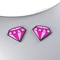 Close-up of pink diamond-shaped acrylic pendants with pre-drilled holes for DIY jewelry - Diamond