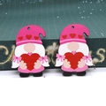 Close-up of wooden Valentine gnomes with red hearts and hanging holes for DIY crafts - Gnome Holding Pink Heart (13)